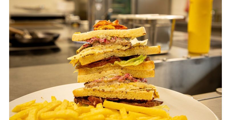 Fresh Club Sandwich with Beef Fillet, Bacon, Fried Egg, and French Fries