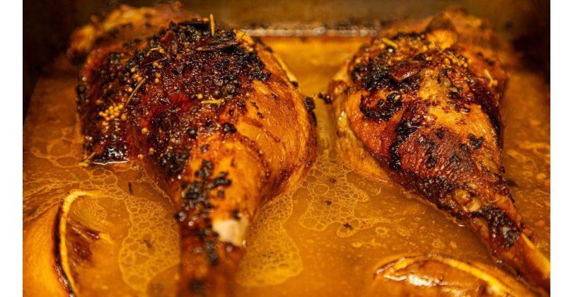 Braised goose leg marinated with white wine, spices, and citrus, served with pickled pumpkin, reduced marinade, and steamed endive with radishes