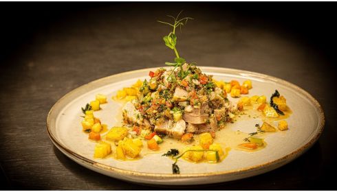 Braised veal head with herb vinaigrette, diced potatoes, carrots and celery fried in butter