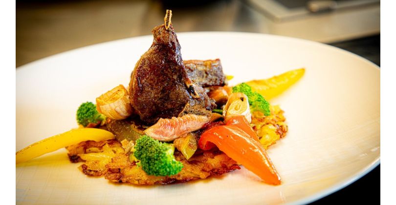 Grilled roe deer chops on potato rösti and grilled vegetables with elderberry and red wine reduction and caramelized figs