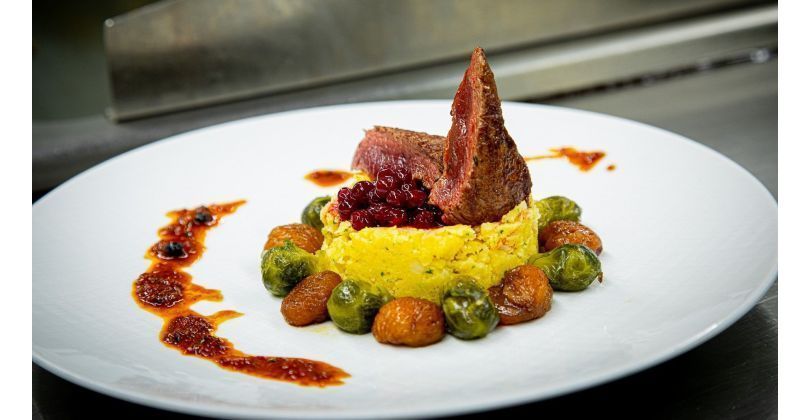 Reindeer entrecote with cranberry sauce, chestnuts, Brussels sprouts, polenta and its jus