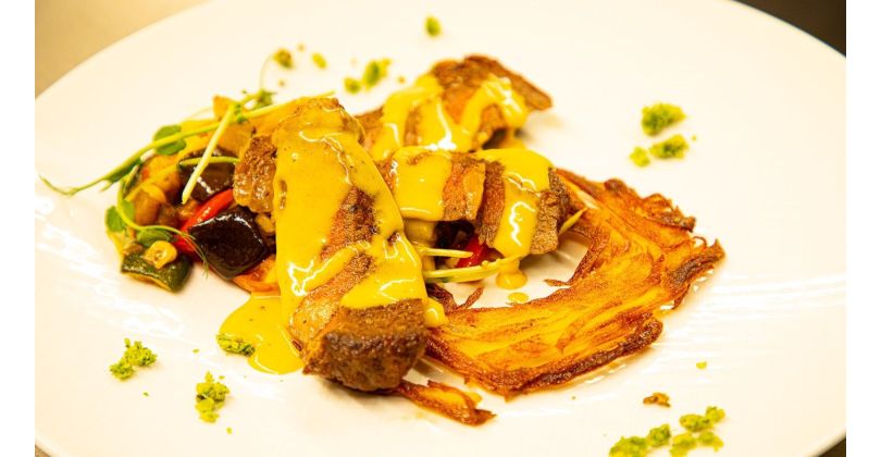 Roast Beef Ribeye on a Potato Nest with Mediterranean Grilled Vegetables and Hollandaise Sauce