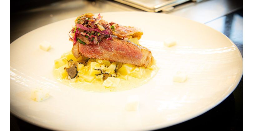 Grilled US Wagyu Beef ribeye on Creamed Celery with Black Truffle Slices and Sautéed Radicchio