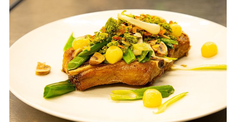 Roast Côte de Boeuf with Herb and Nut Crumble on Onion and Potato Vegetables