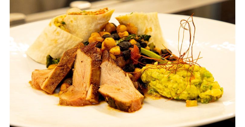 Burrito with zebra fillet, fresh guacamole, crunchy vegetables, and spicy tomato salsa